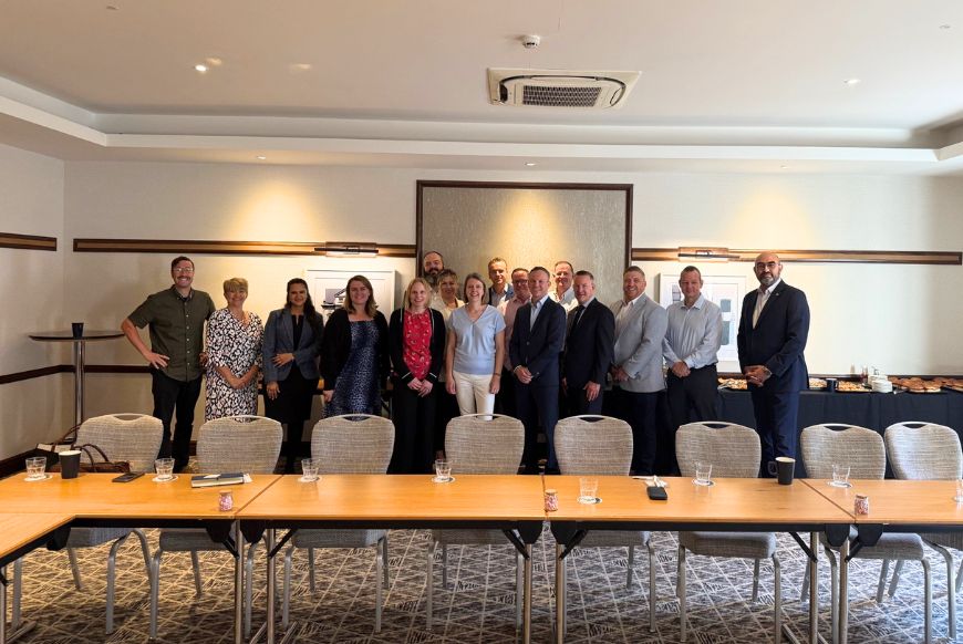 a group of people in a buisness meeting room